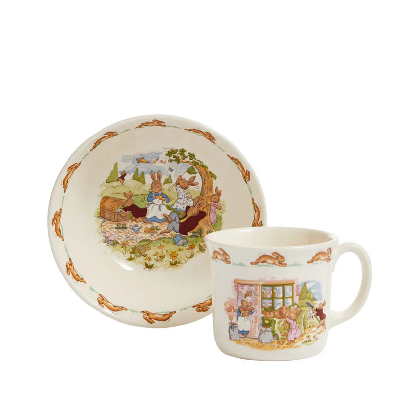 Ceramic mug and plate set with illustrated design on a white background