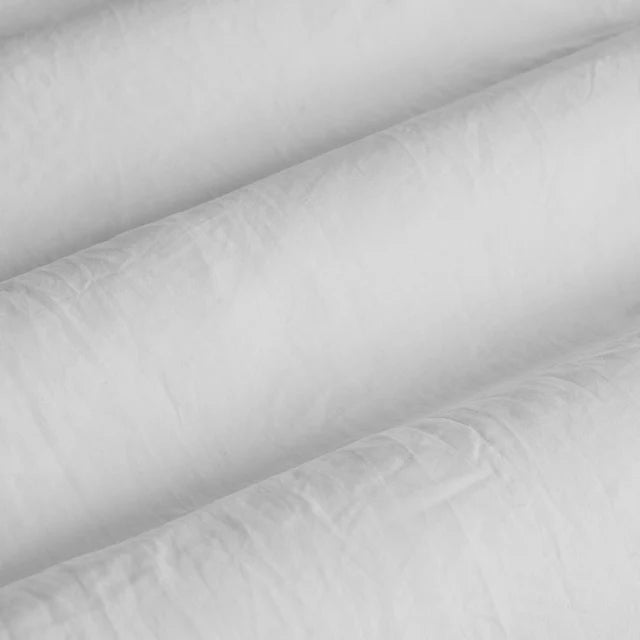 Close-up of white quilted fabric with a soft texture