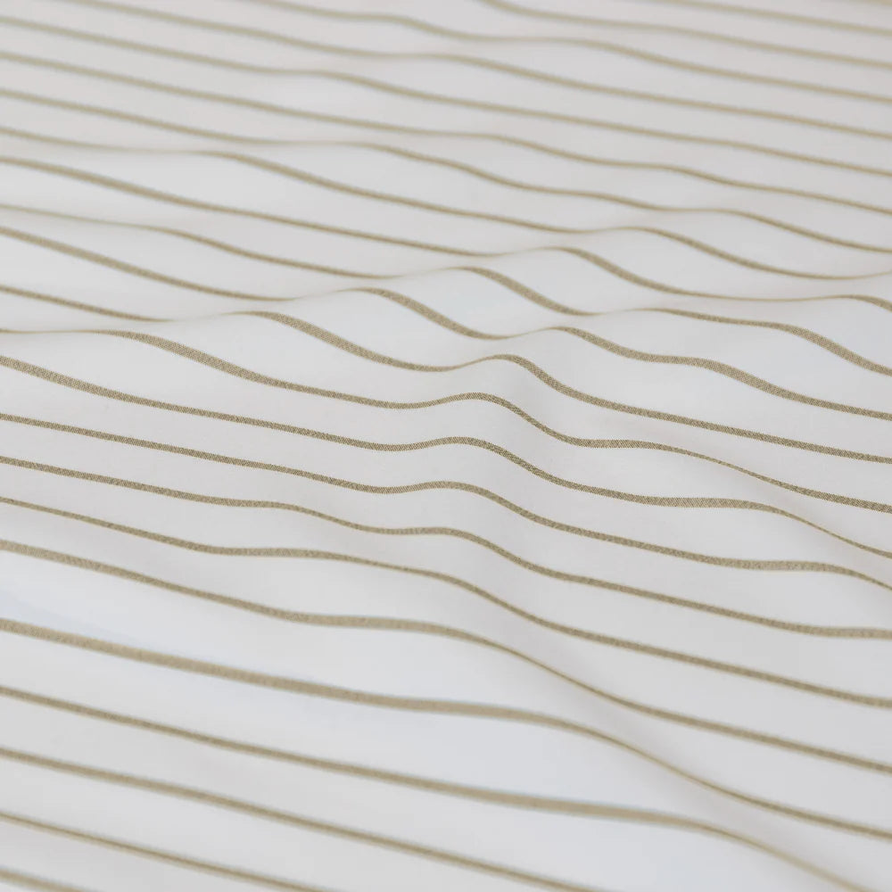 Close-up of fabric with wavy brown lines on a white background