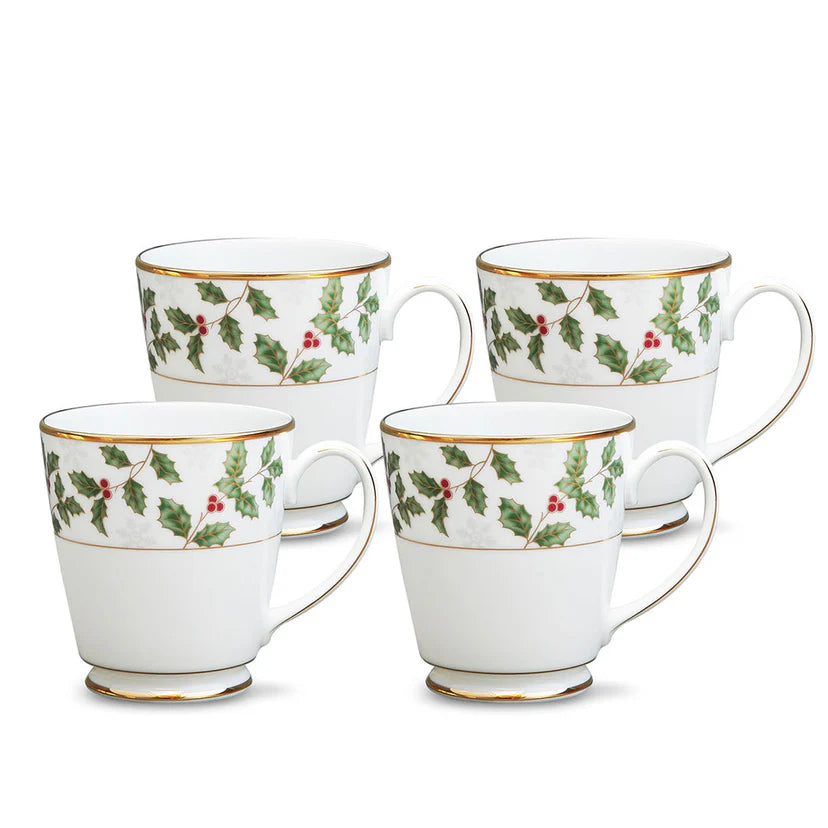 Set of four white mugs with holly berry design on a white background