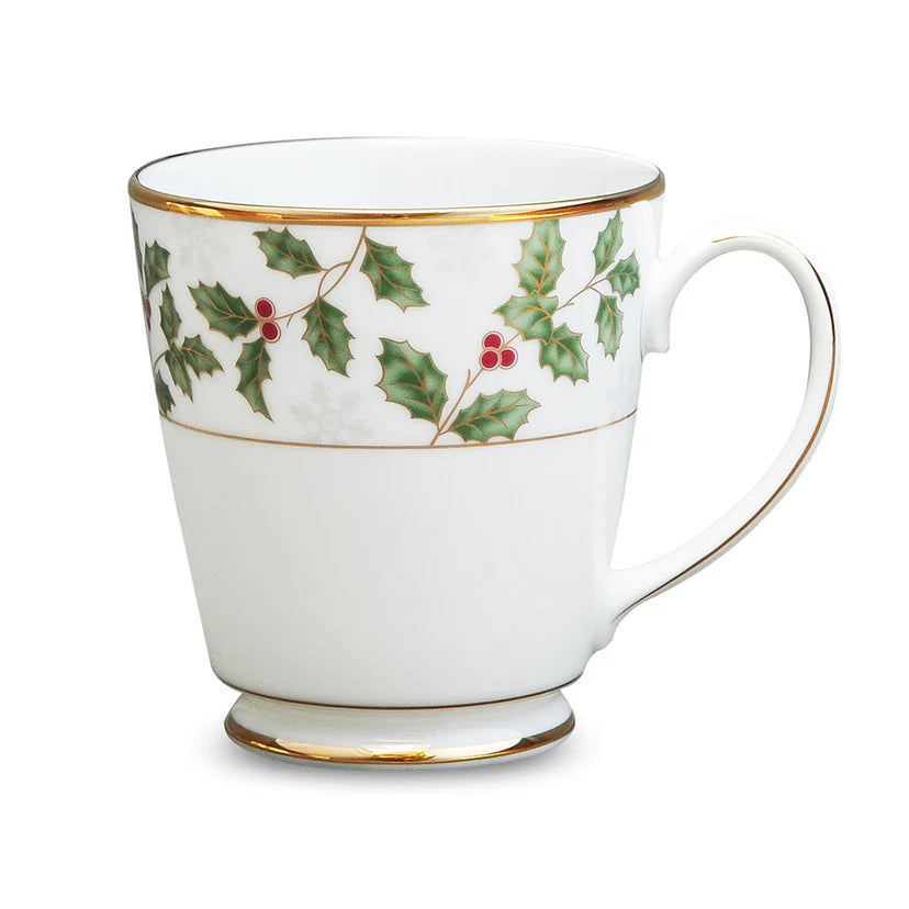 White mug with holly design on a white background