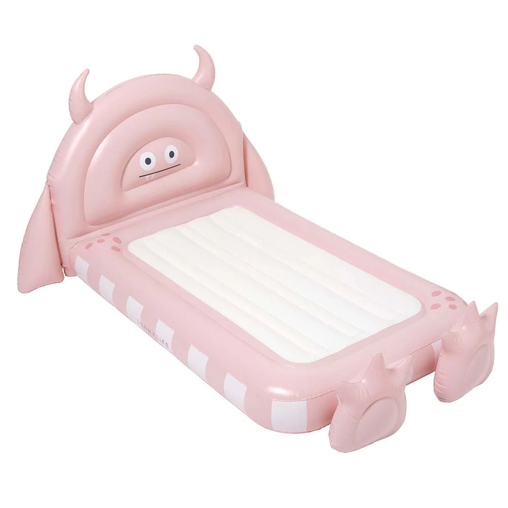 Pink inflatable monster-shaped pool float on a white background