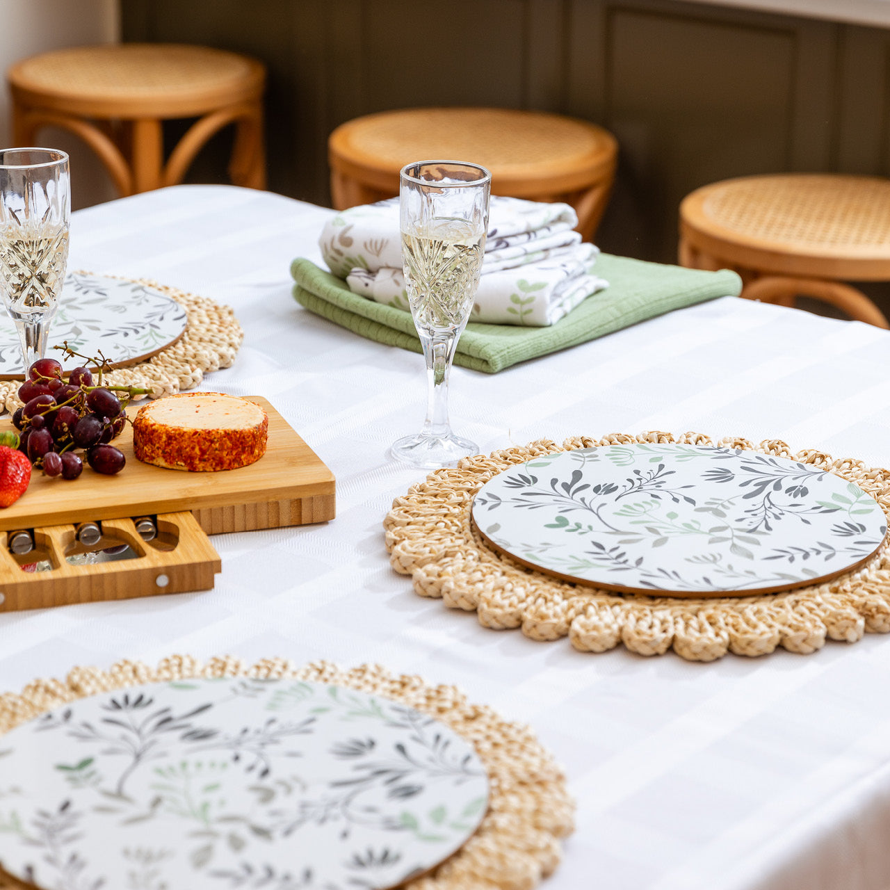 Lifestyle shot of Ambrosia Placemats on a dining table with wine and platter