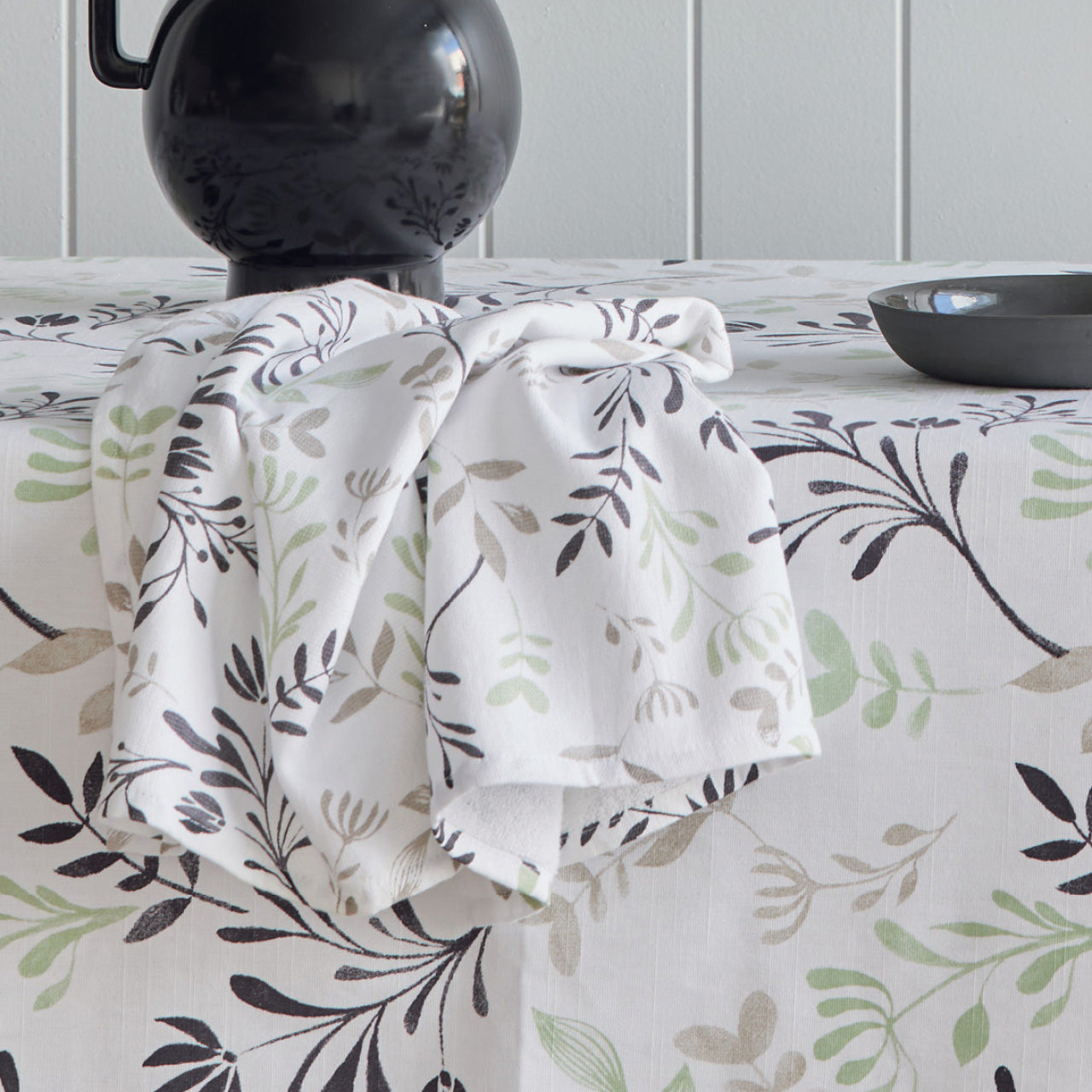 Zoomed in shot of Ambrosia Tablecloth and Tea Towels on a dining table