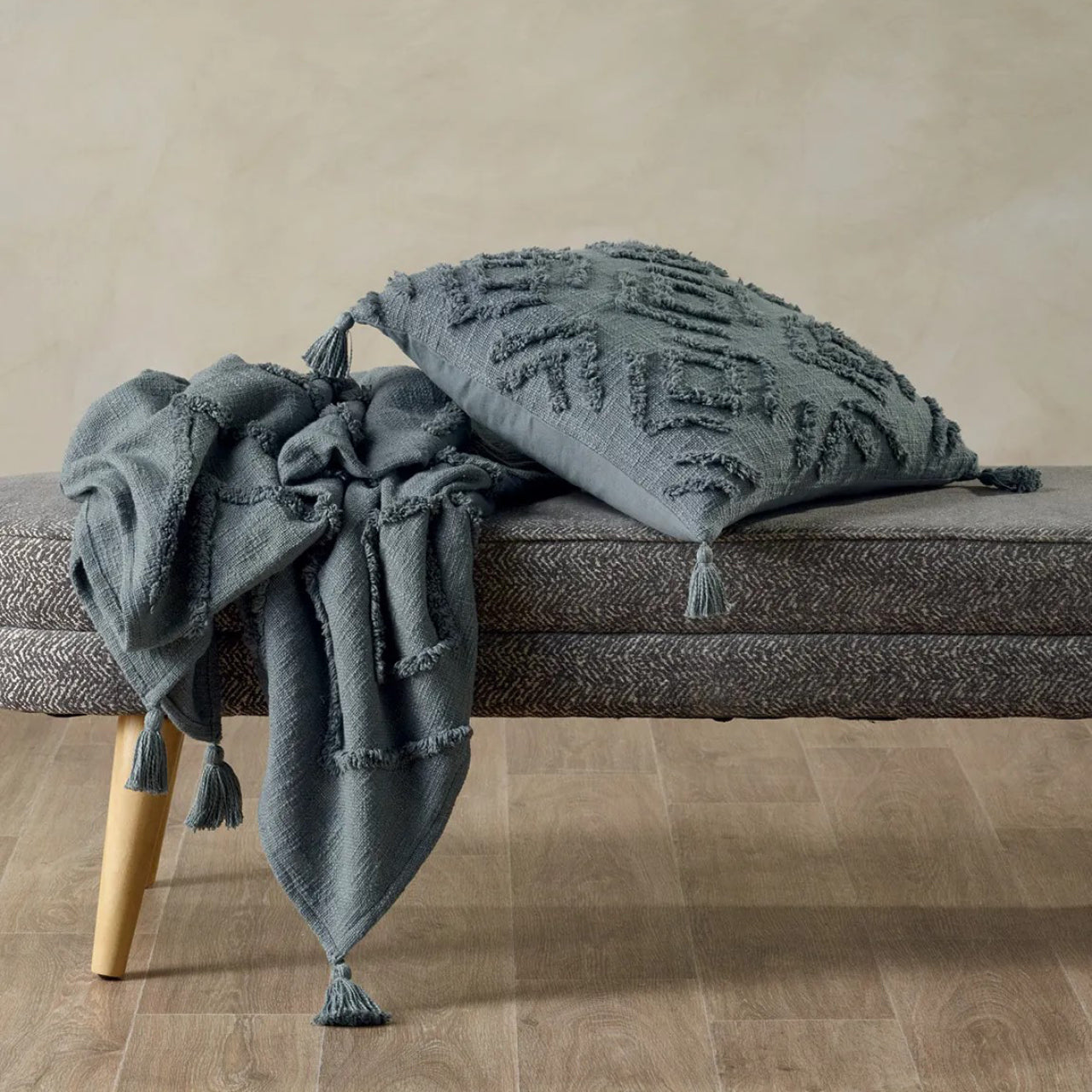 Aspen Cushion Cover and Throw Grey on a stool and on floor