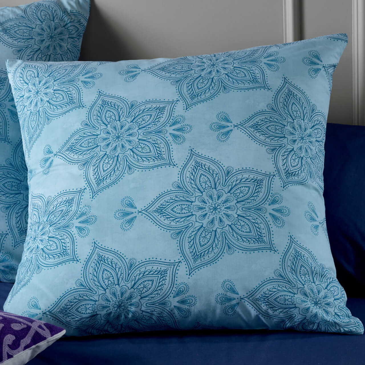 Zoomed in shot of Astra European Pillowcases on bed