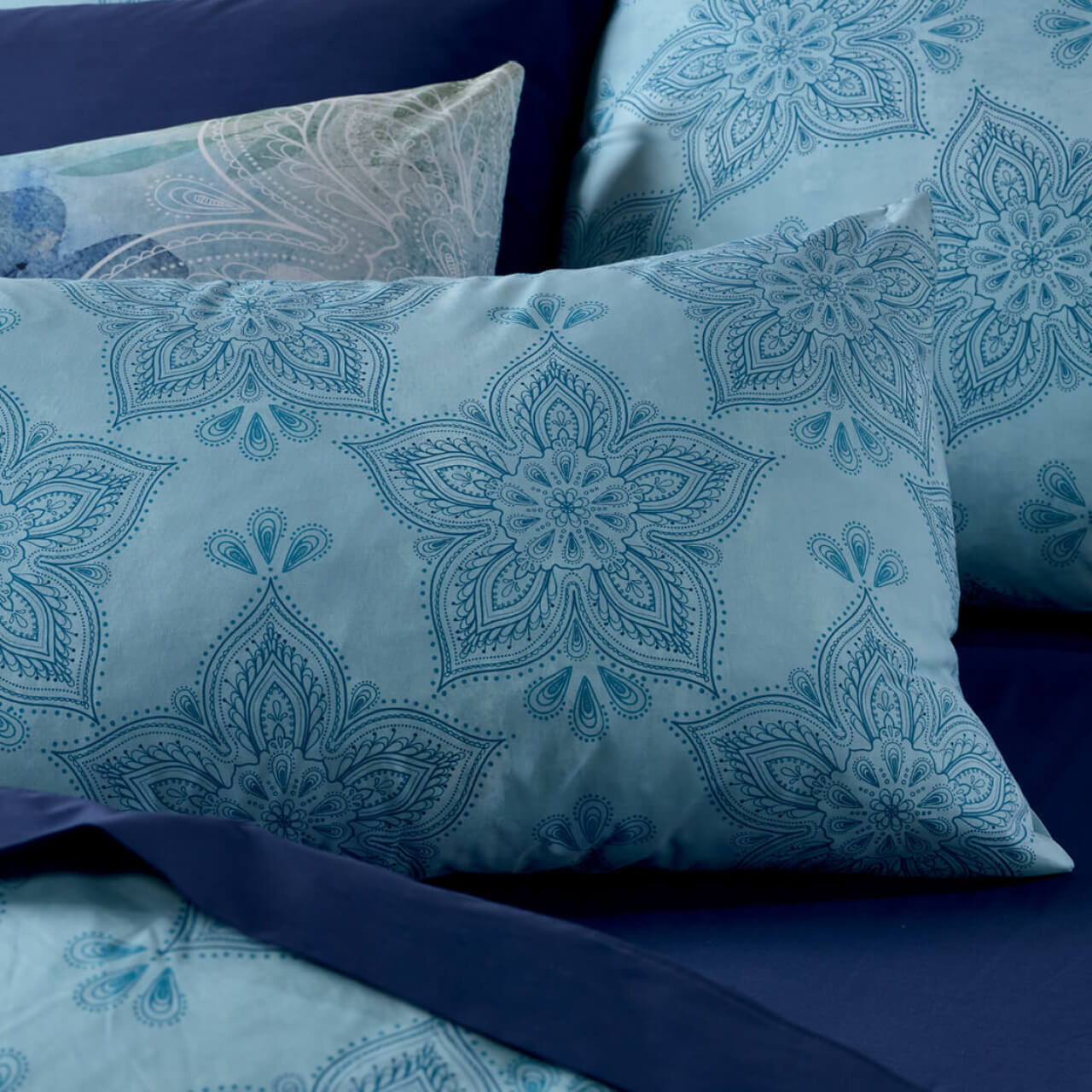 Close up shot of Astra pillowcases on bed