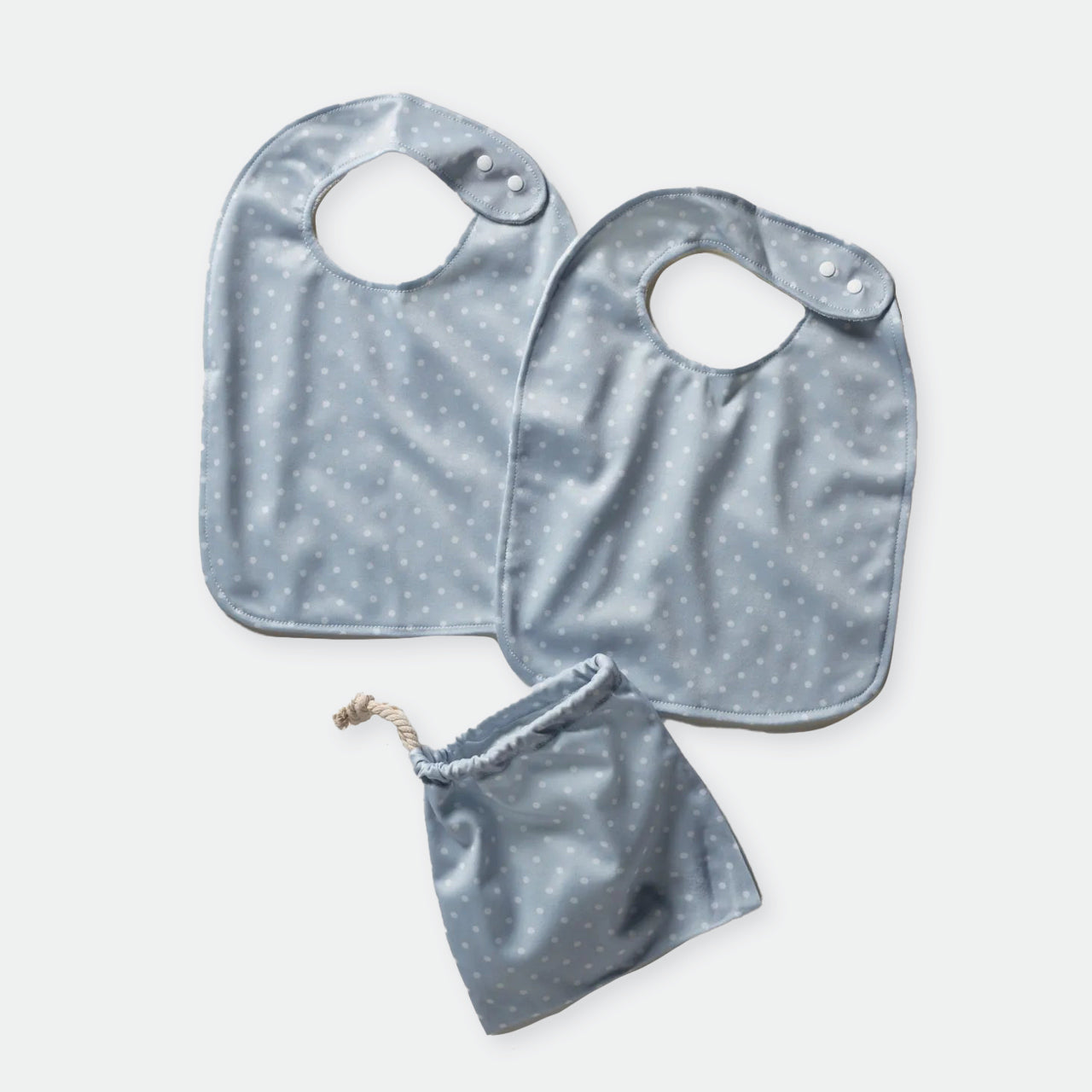 Baby Basics Grey Bibs and bag on a white background