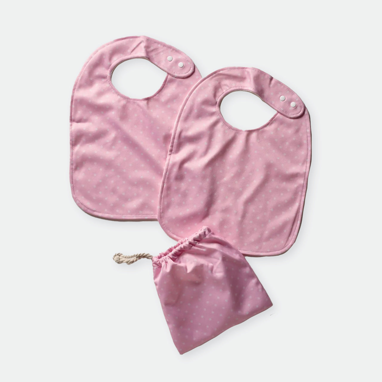 Baby Basics Pink Bibs and bag on a white background