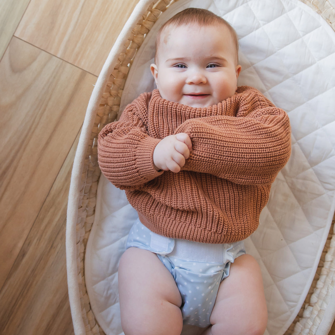 Lifestyle shot of Baby Basics Blue Reusable Nappy on a baby