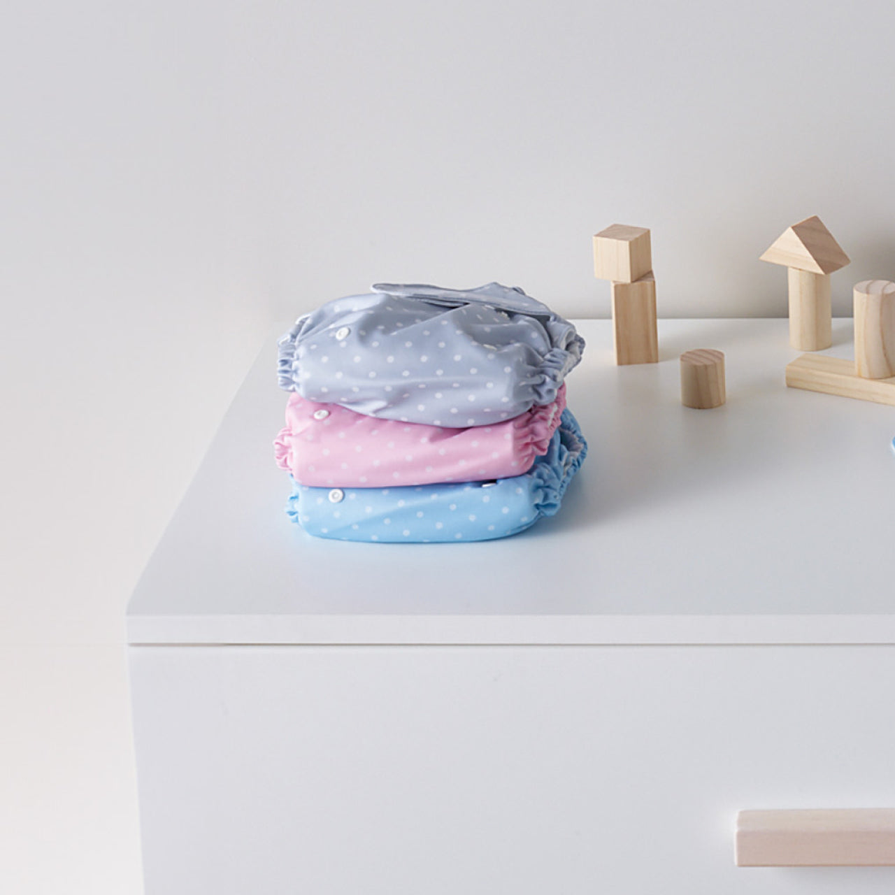 Lifestyle shot of all Baby Basics Reusable Nappies on a table