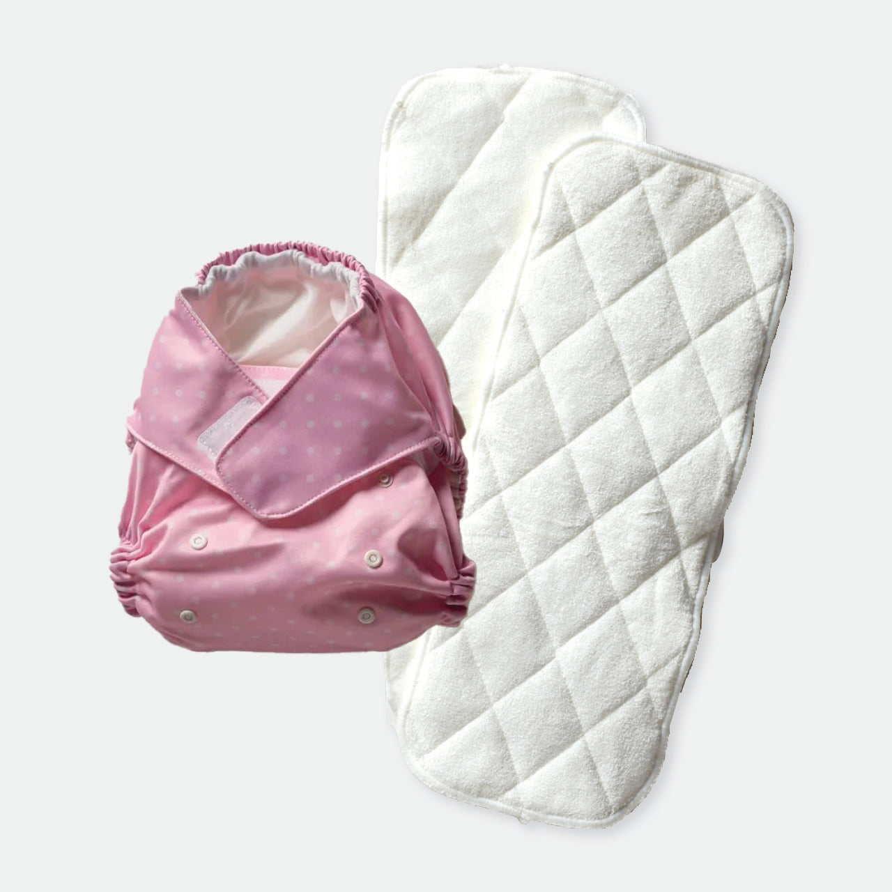 Baby Basics Pink Reusable Nappy and liners on a white background