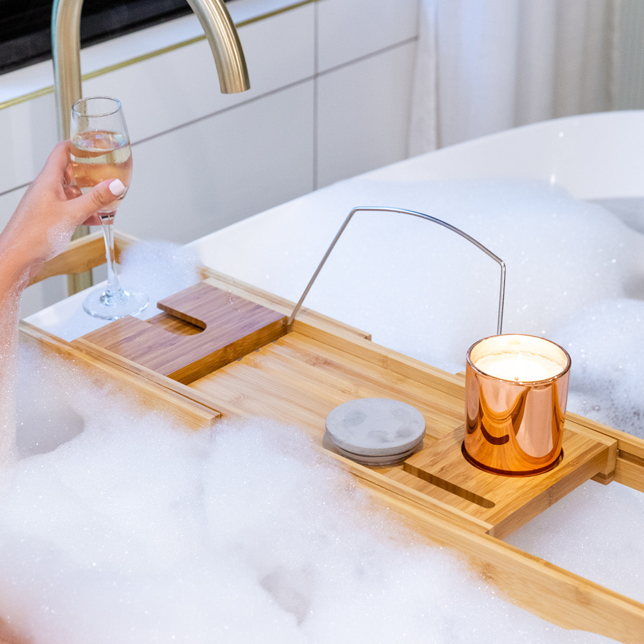 Lifestyle shot of Bamboo Bath Caddy over bath with bubbles
