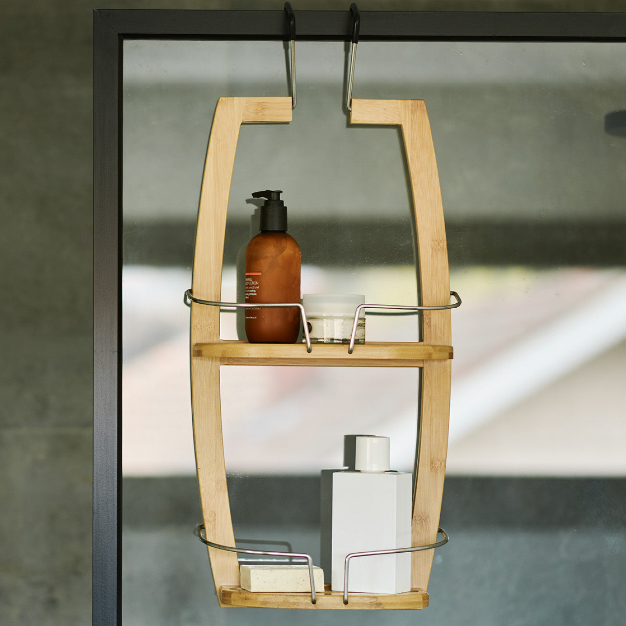 Bamboo Shower Caddy hanging over glass with soaps inside