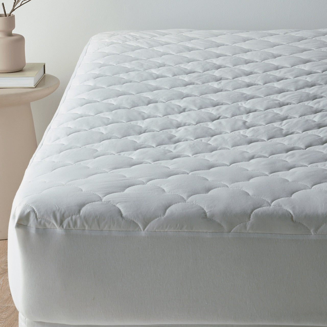 Front on view of Bamboo Wool Mattress Protector on bed 