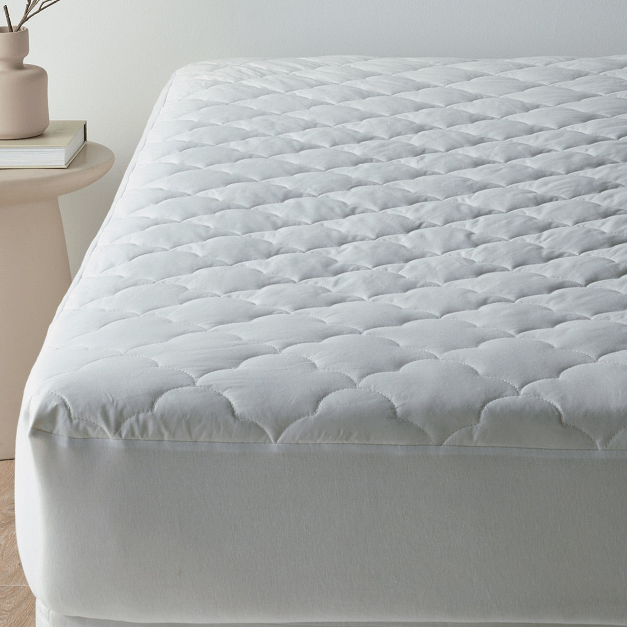 Front on view of Bamboo Wool Mattress Protector on bed