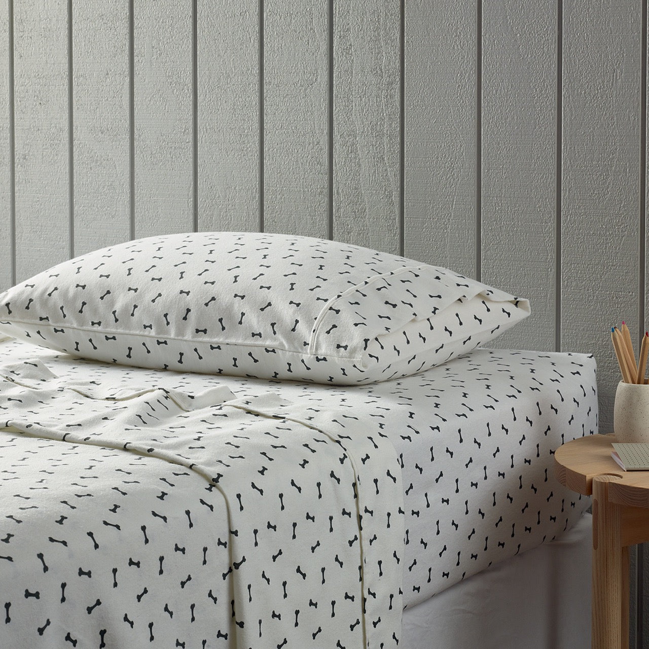 Side view of Bones Flannelette Sheets on bed