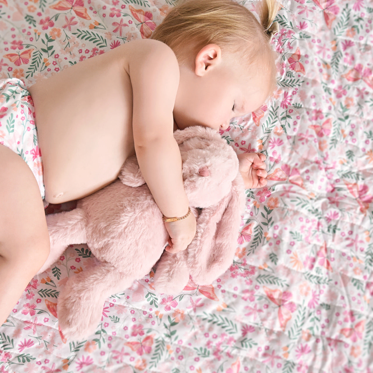 Lifestyle shot of baby hugging Botanical Soft Toy