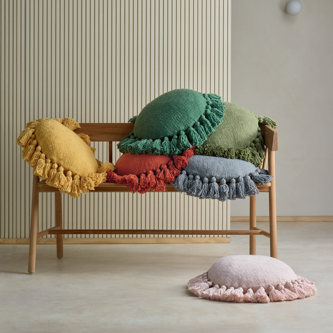 Group shot of Cadence Cushions on a bench