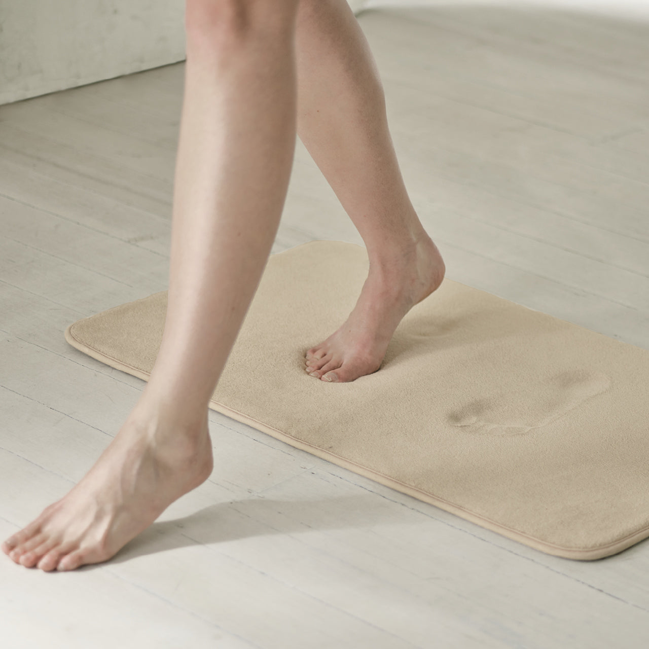 Person stepping onto Cameron Memory Foam Bath Mat Stone