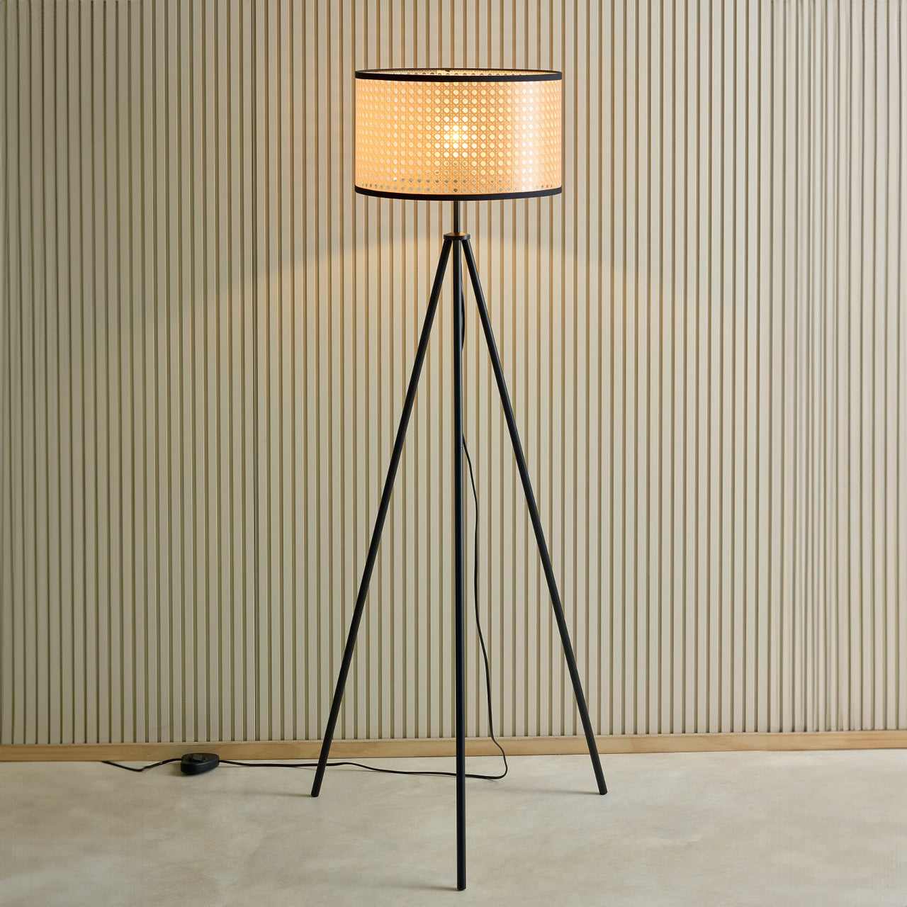 Conrad Floor Lamp turned on against a wall