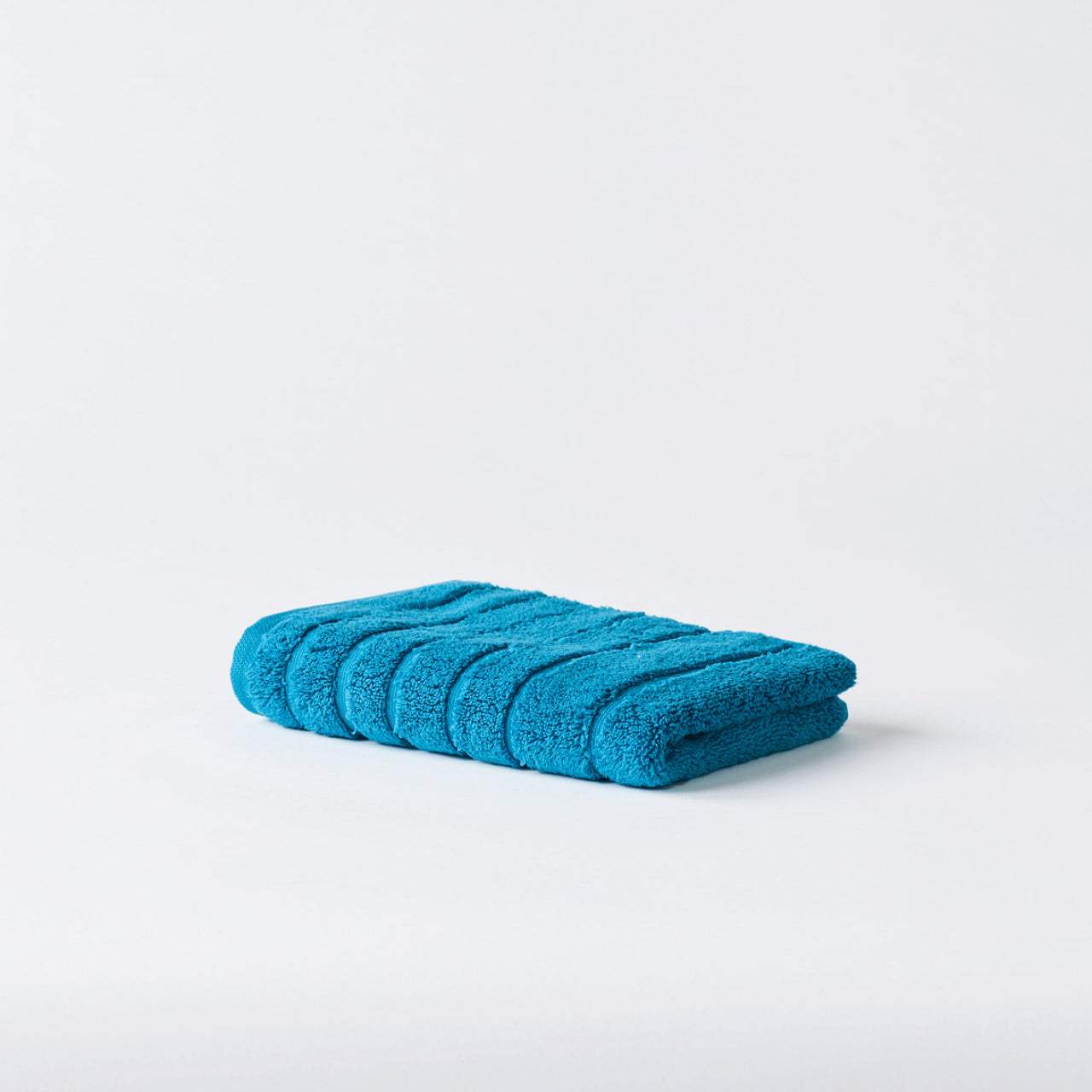 Cooper Hand Towel Peacock Blue on a white background