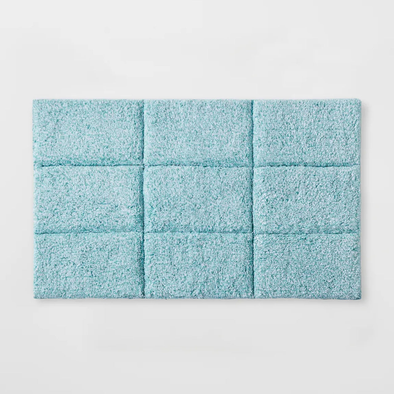 Cooper Tufted Bath Mat Mint on a white background