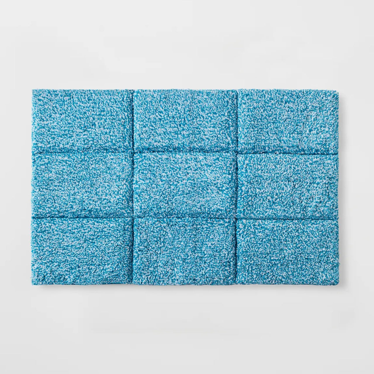Cooper Tufted Bath Mat Peacock Blue on a white background