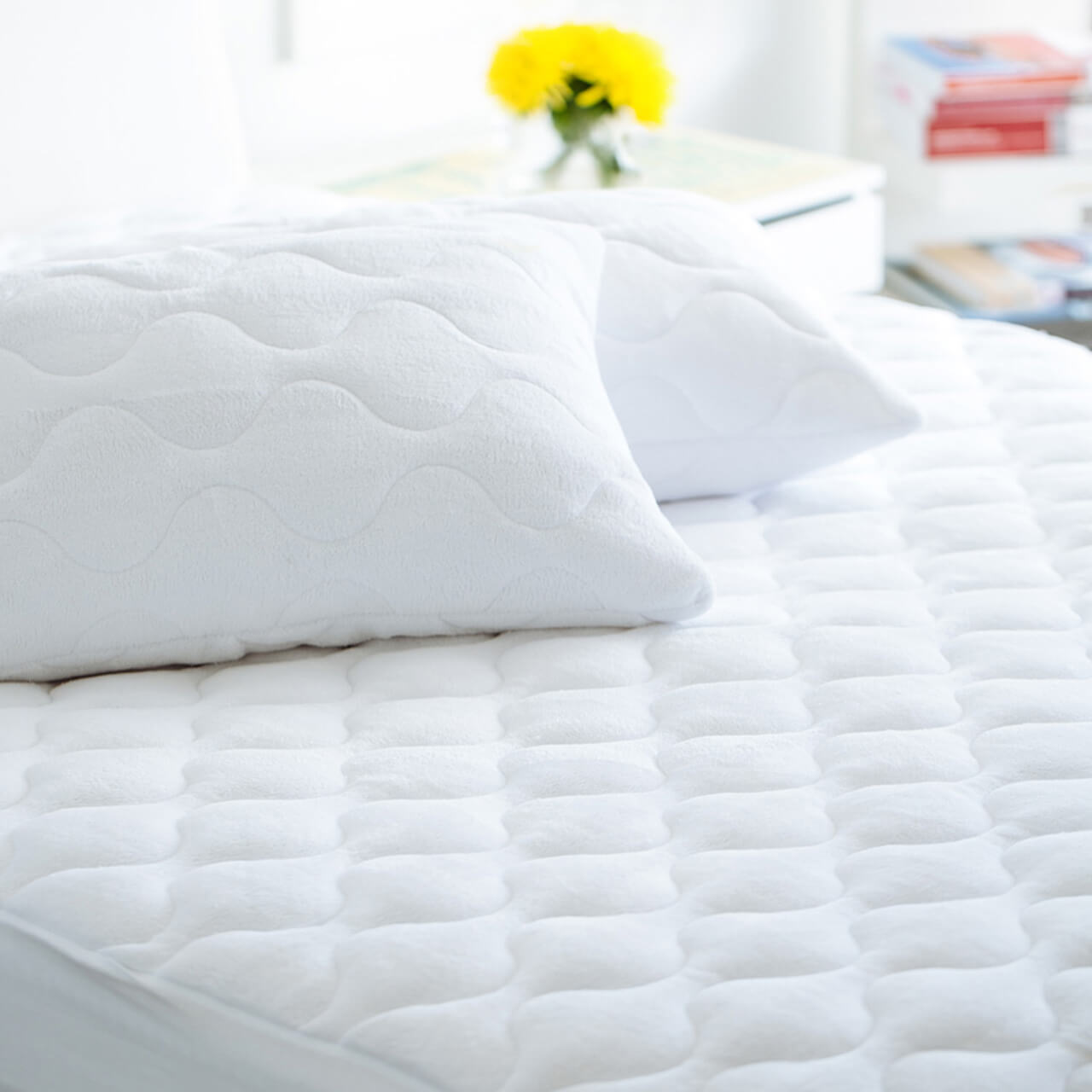 Zoomed in shot of Coral Fleece Matress Protector on bed with Coral Fleece Pillow Protectors