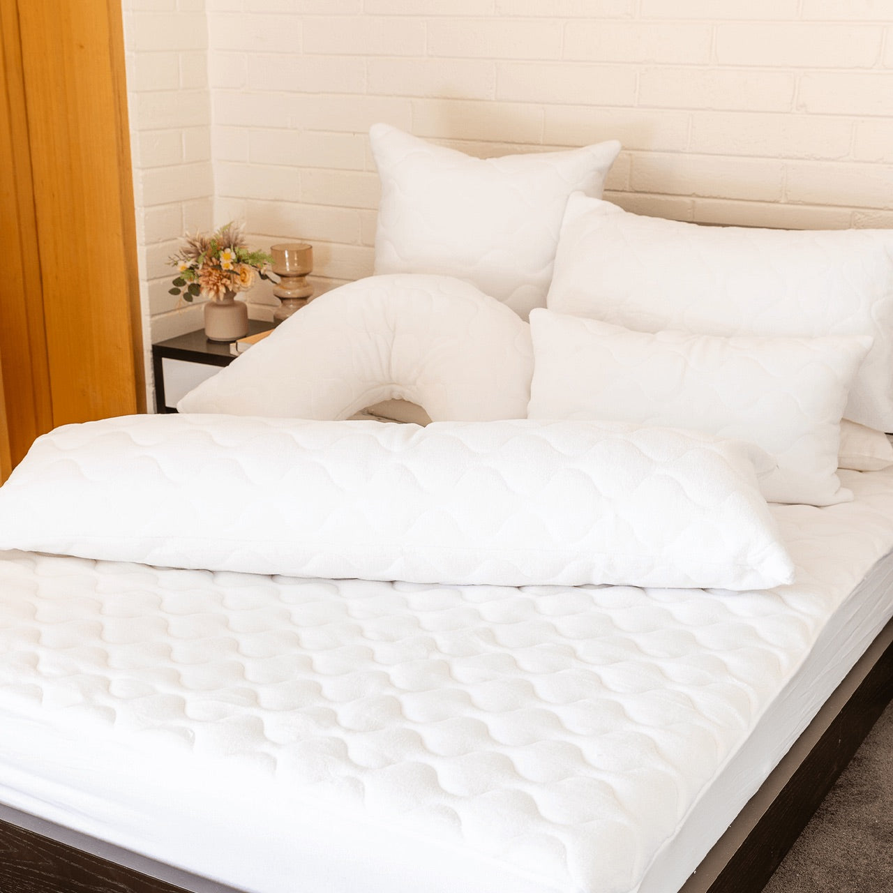 Group shot of Coral Fleece Pillow Protectors on bed