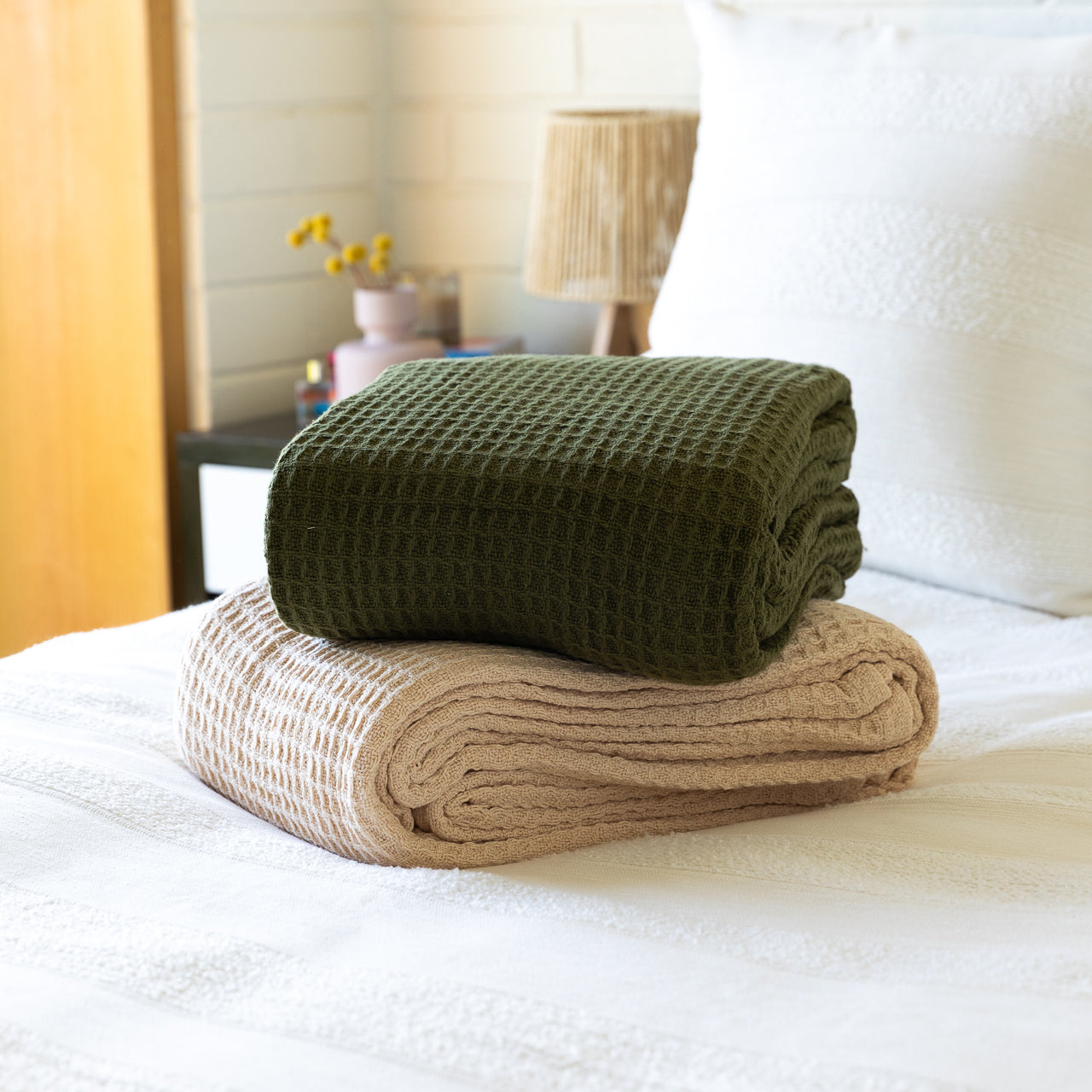 Group shot of Cotton Blankets folded up on bed