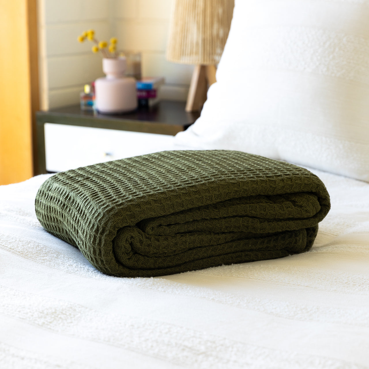 Cotton Blanket Olive folded up on bed