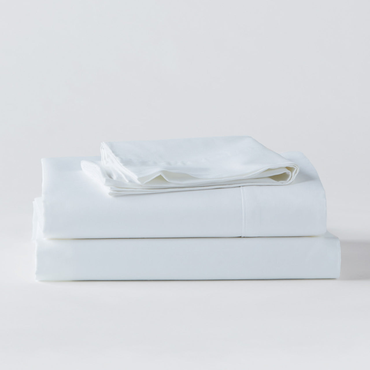 Cotton White Sheets folded up on floor