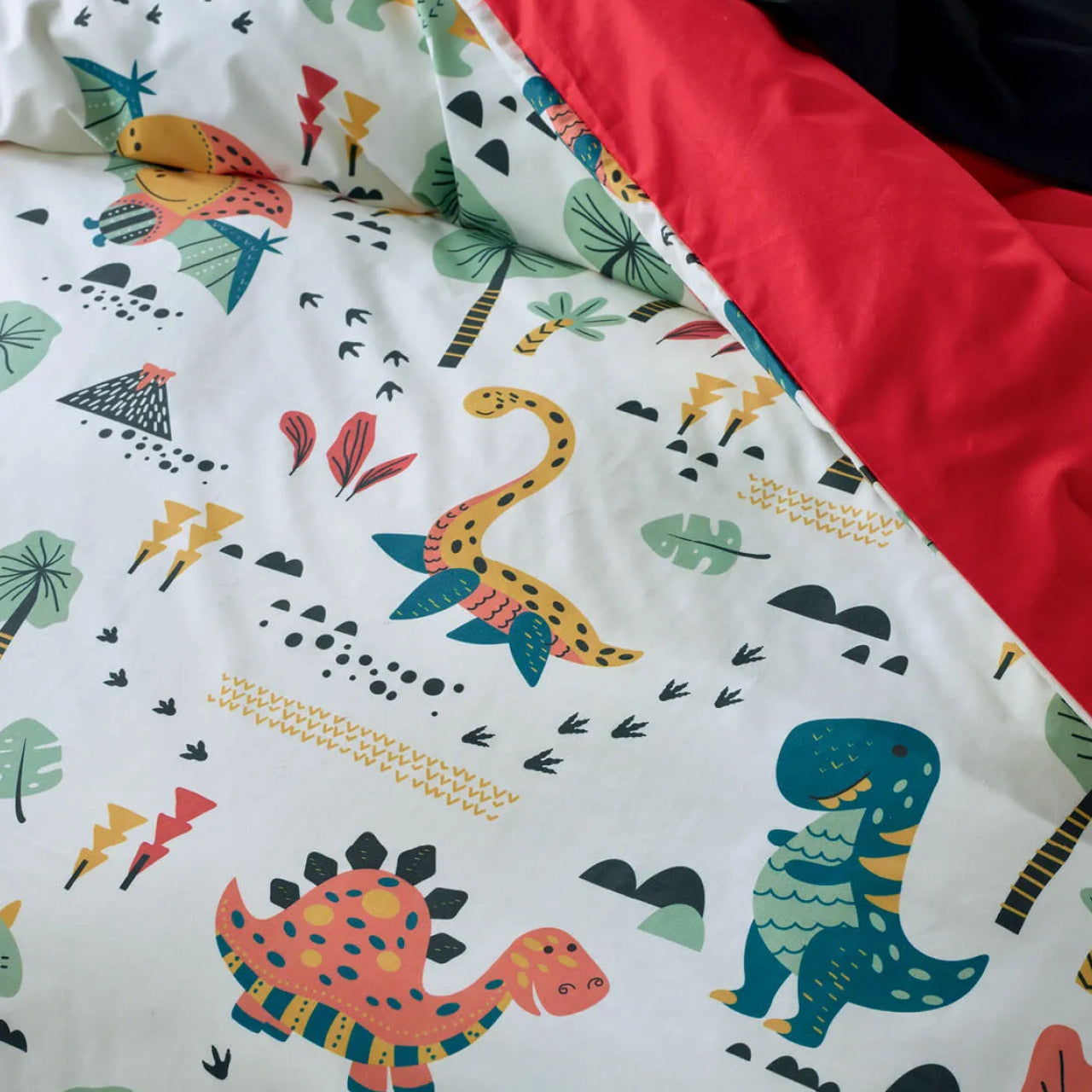 Close up shot of Dino Quilt Cover on bed