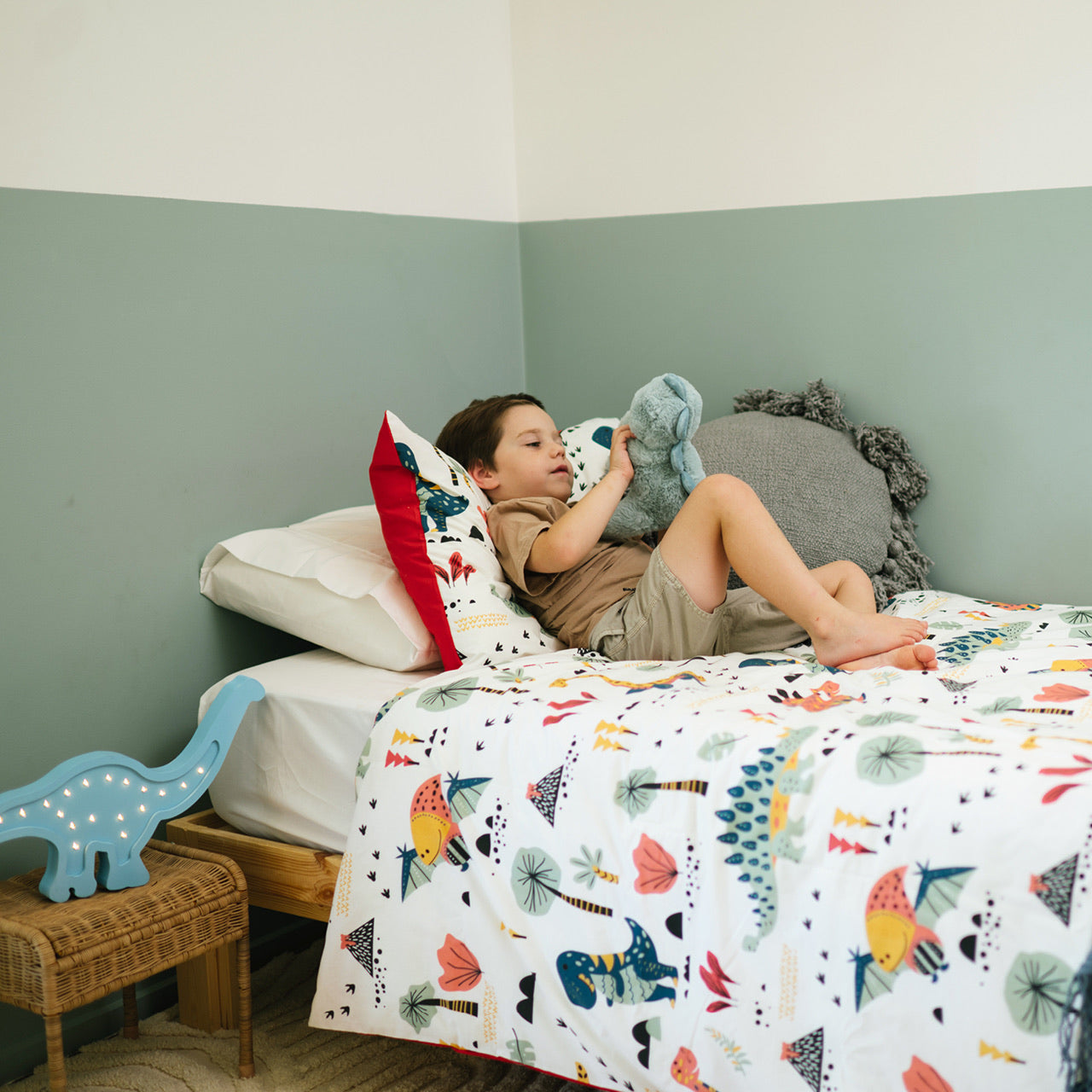 Lifestyle shot of boy playing on Dino Quilt Cover Set