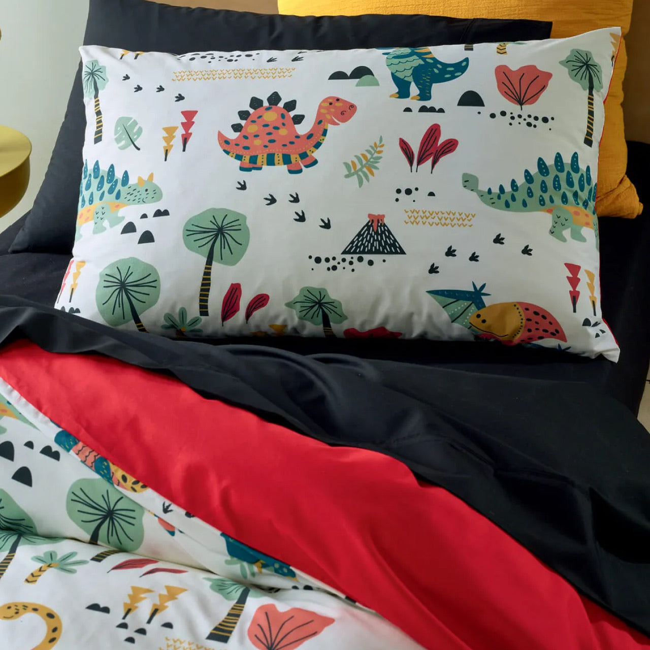 Close up shot of Dino Pillowcases on bed