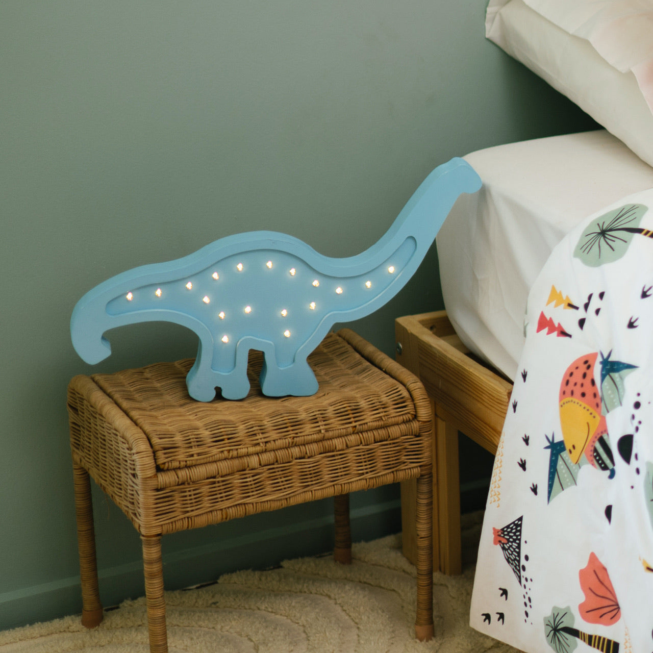 Lifestyle shot of Dinosaur Wooden Light next to bed