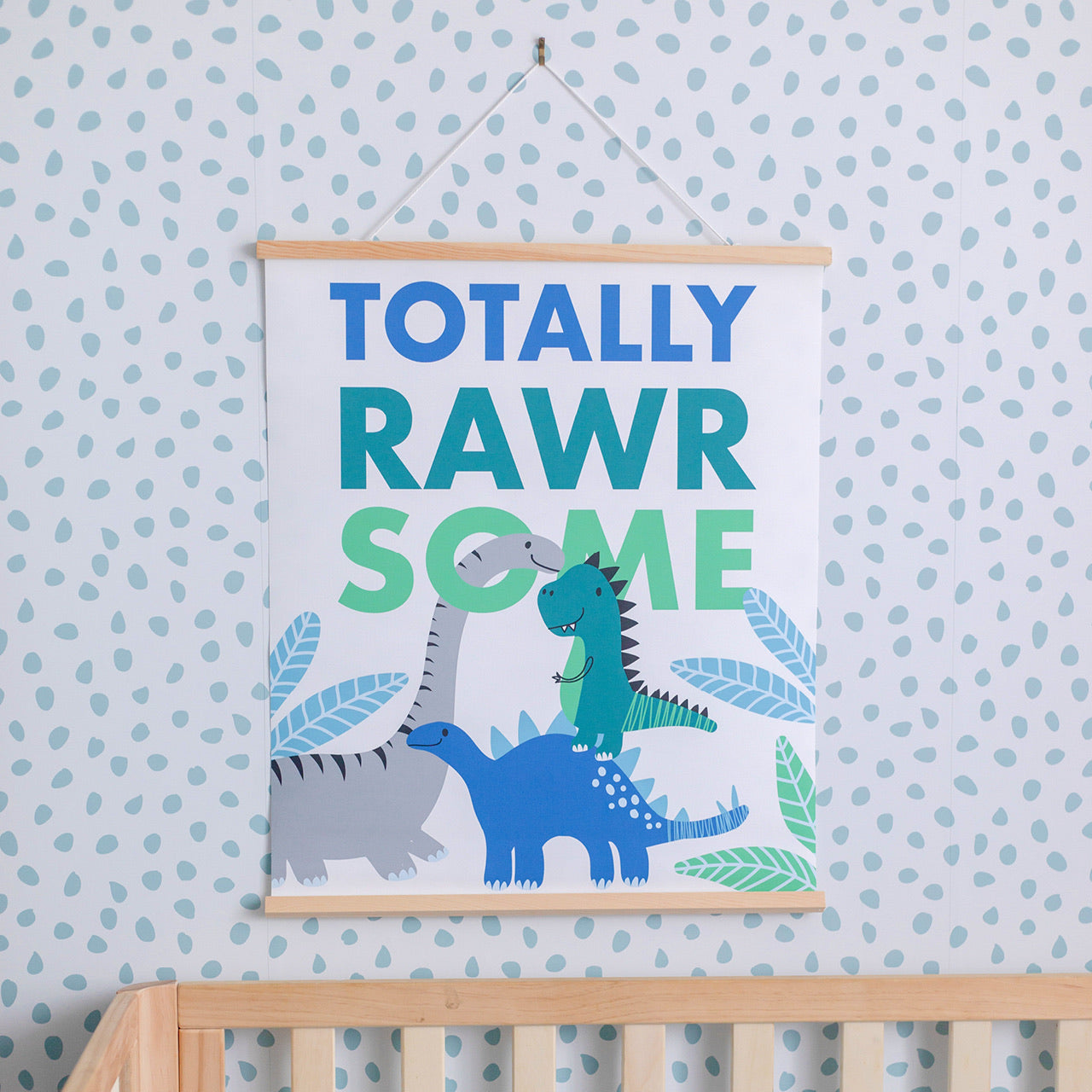 Lifestyle shot of Dinosaur Wall Art hanging over cot