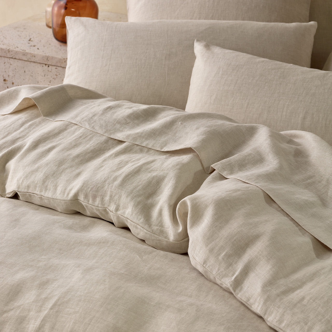 Close up shot of Elayna Quilt Cover Natural on bed