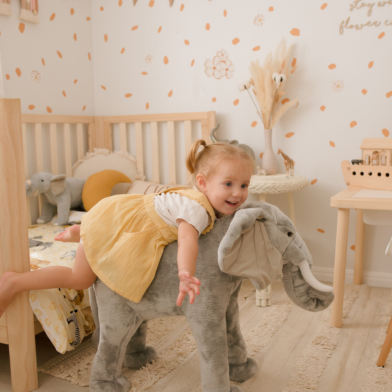 Lifestyle shot of child sitting on Elephant Standing Animal in bedroom