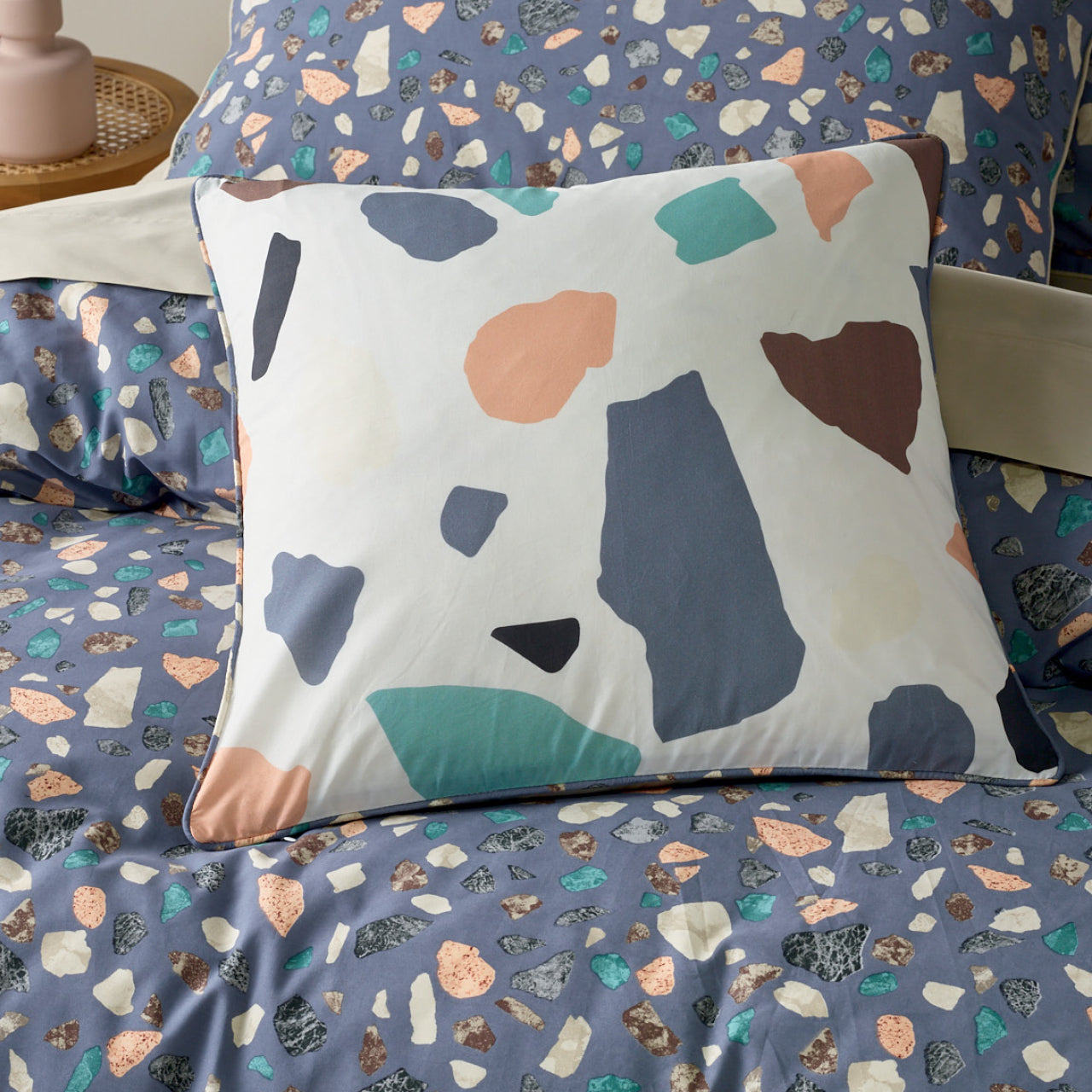 Zoomed in shot of Gemstone Cushion Cover on bed