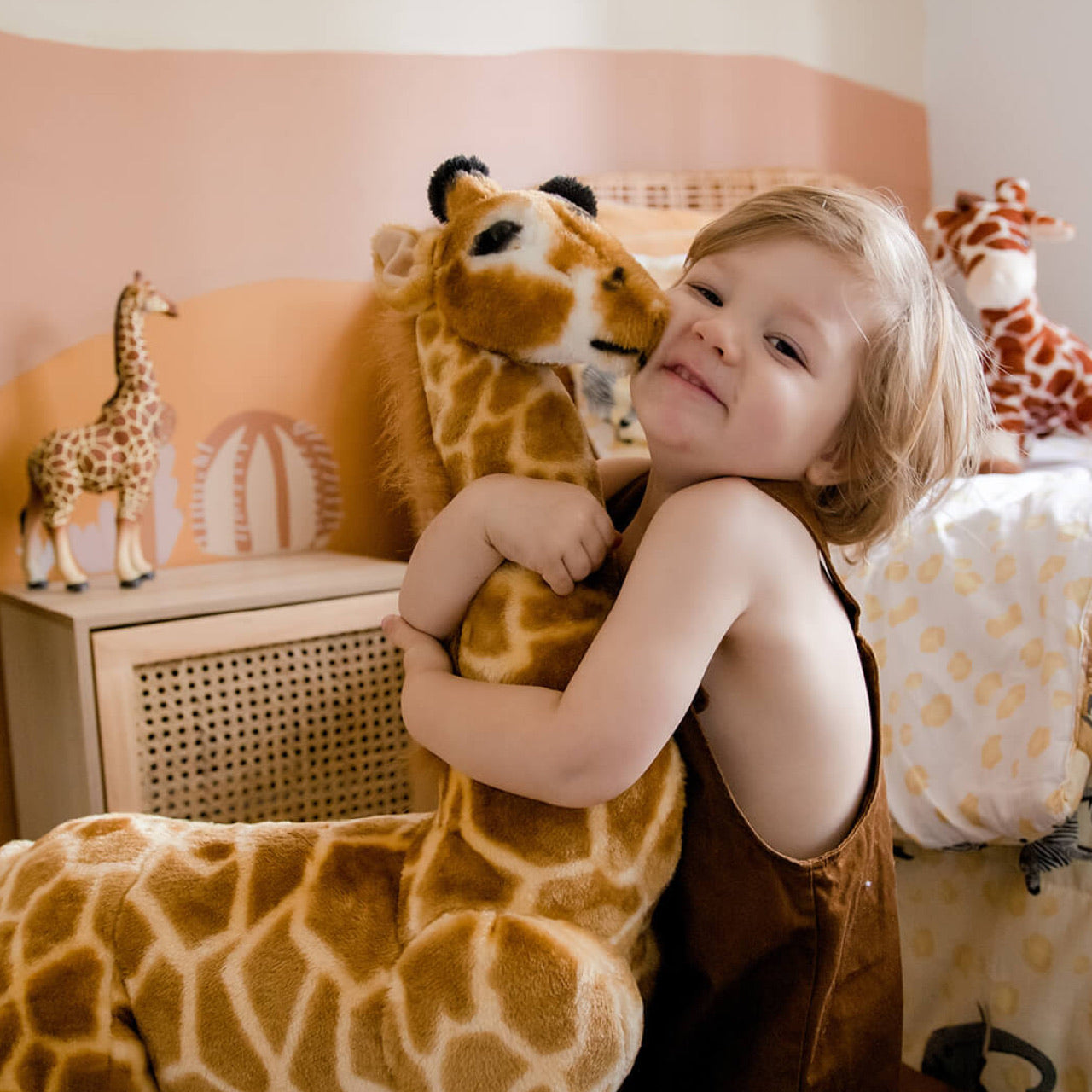 Lifestyle shot of child playing with Giraffe Standing Animal