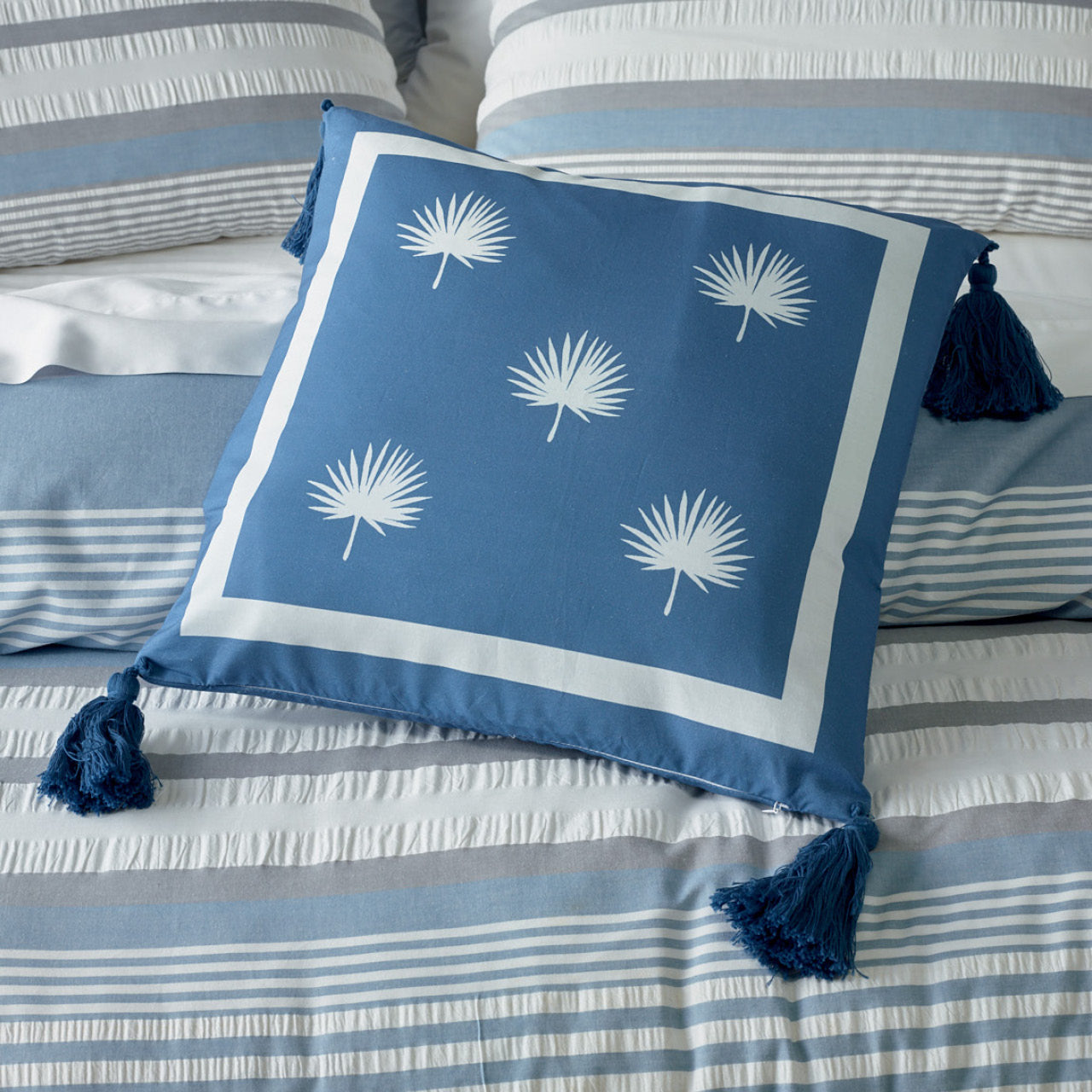 Zoomed in shot of Hampton Cushion Cover on bed