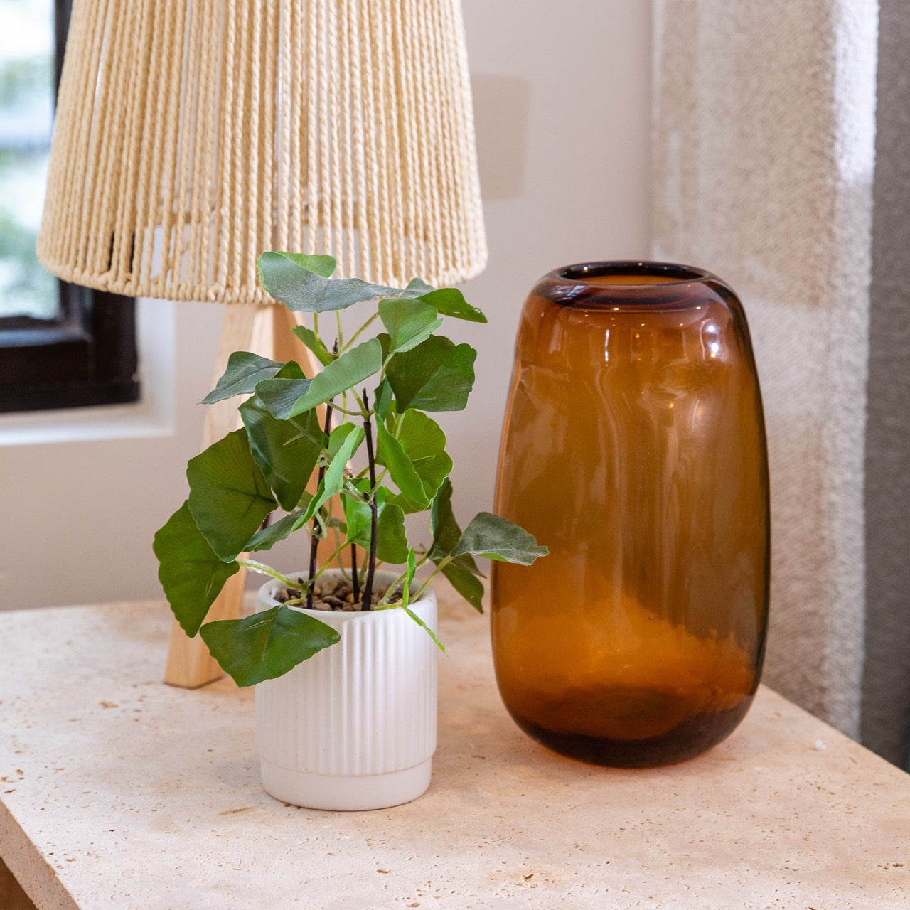 Lifestyle shot of Indiana Vase Amber 22cm on a bedside table