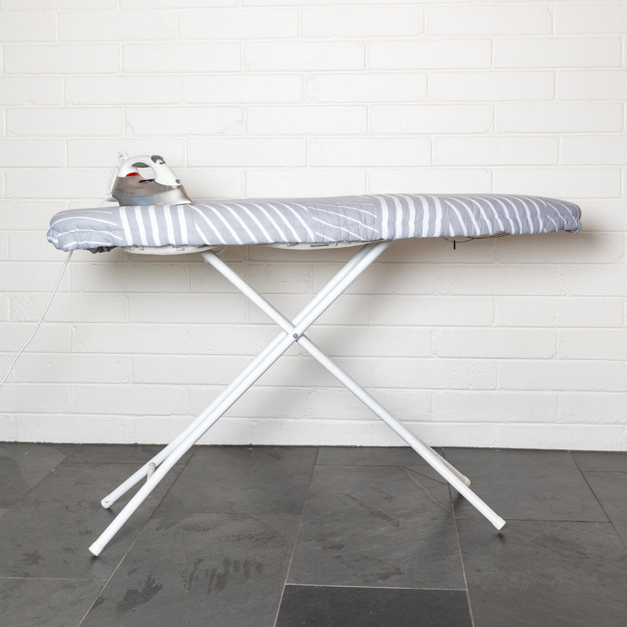 Ironing Board Cover on ironing board standing up with iron