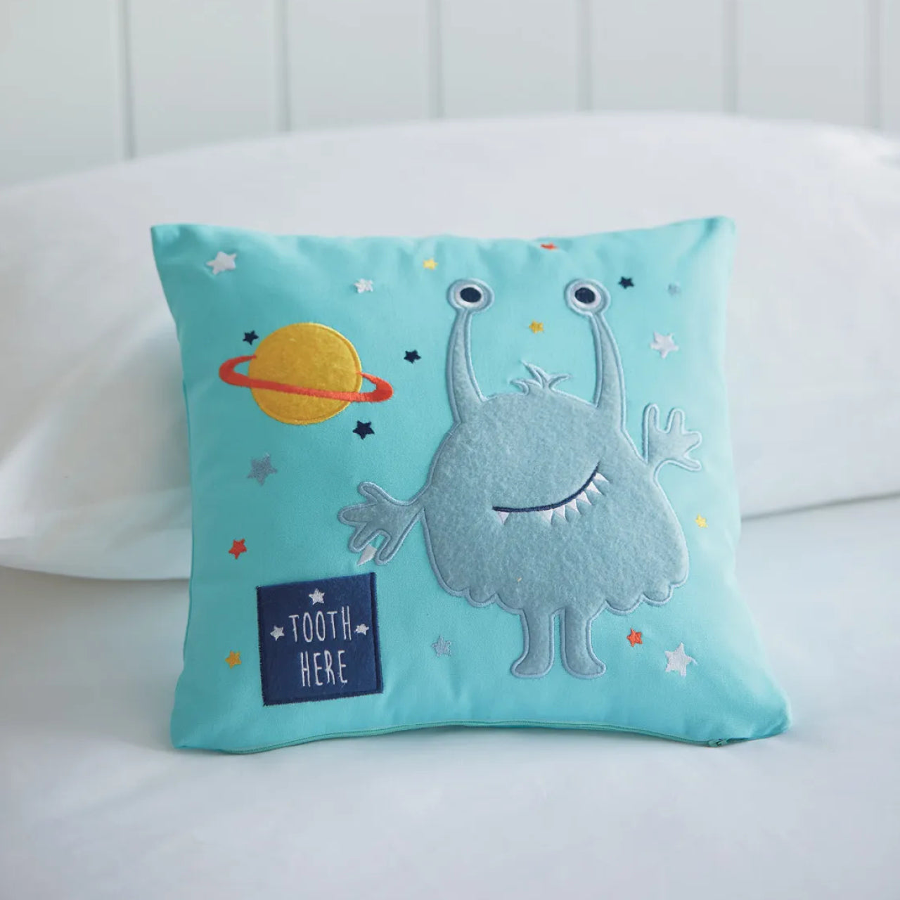 Monster Novelty Cushion sitting up on bed