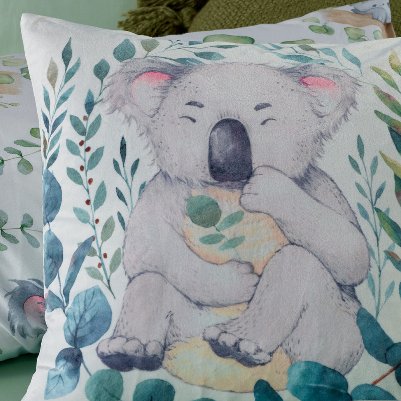 Close up of Koala Cushion Cover on bed