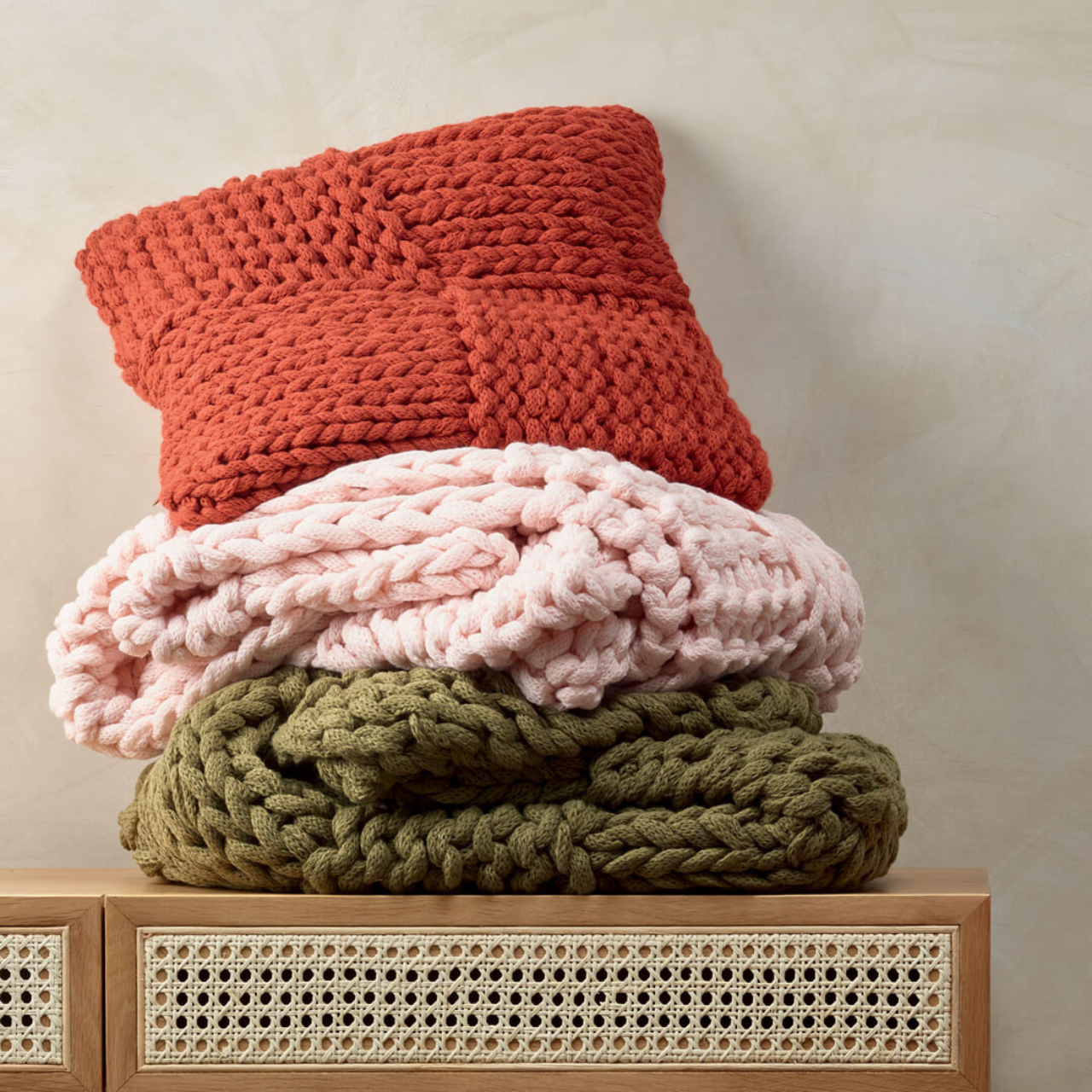 Meridian Cushion Terracotta and throws close up