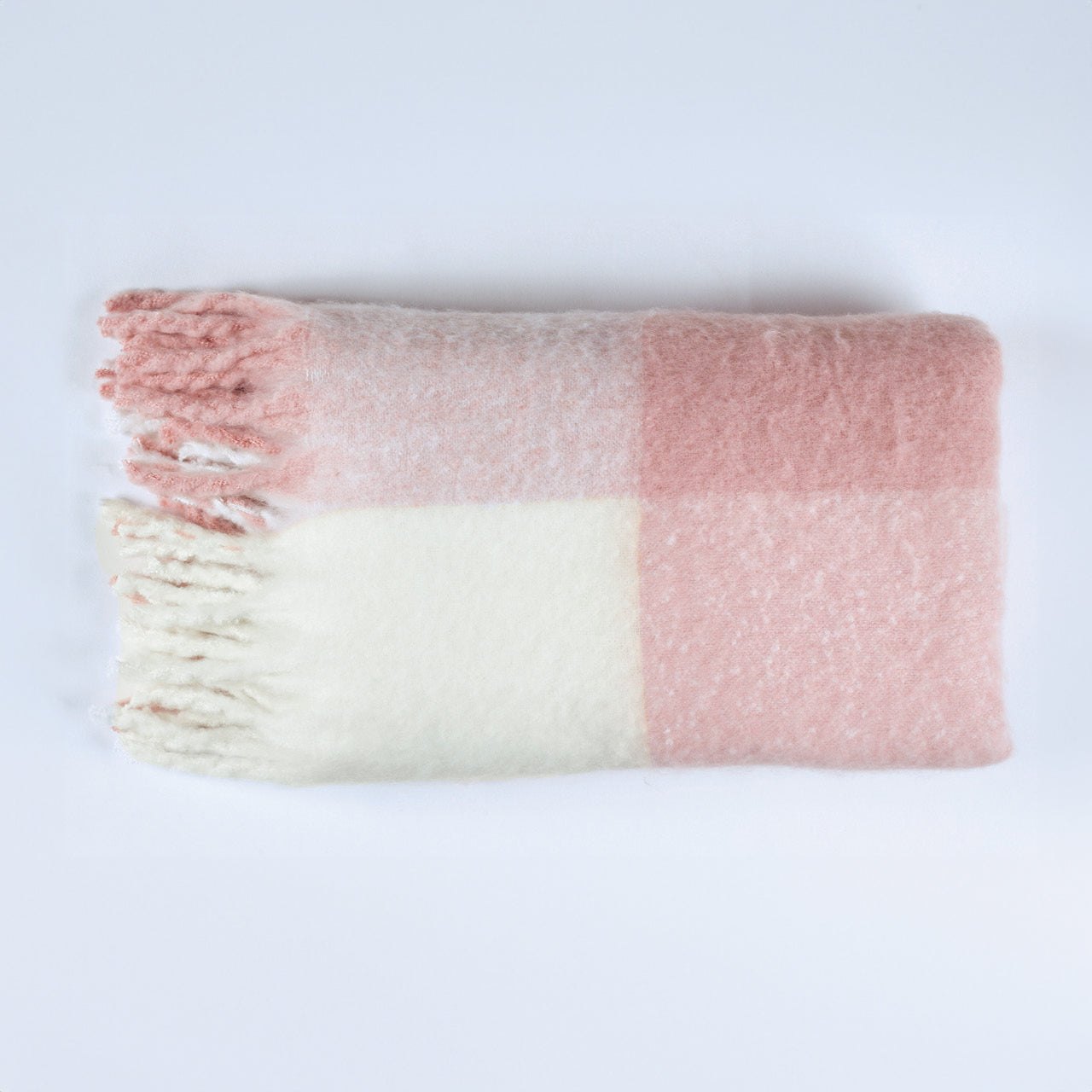Penelope Throw Blush rolled up on white background