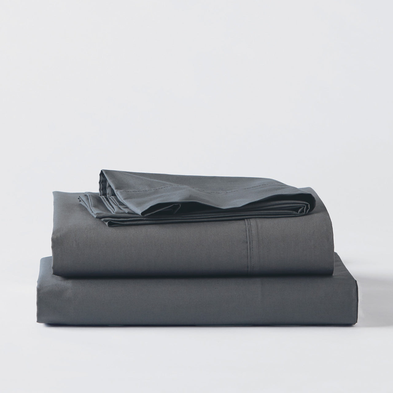 Premium Percale Charcoal Sheets folded up on floor